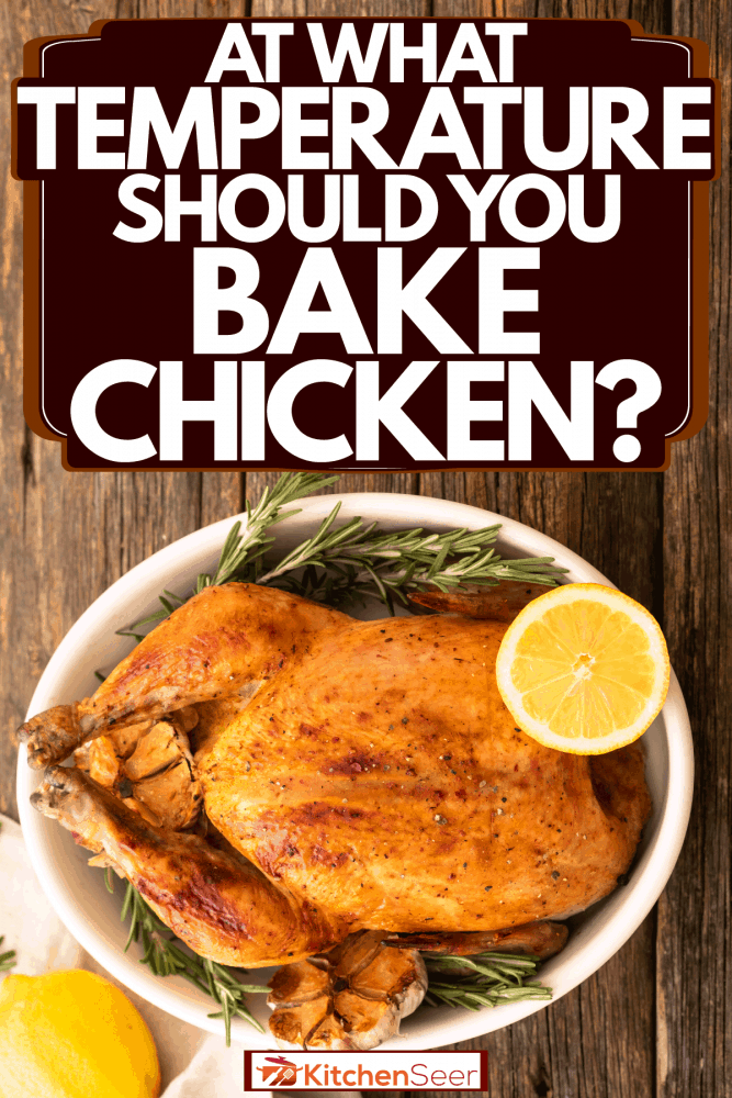 A hole baked chicken with oregano, sliced garlic and lime, At What Temperature Should You Bake Chicken?