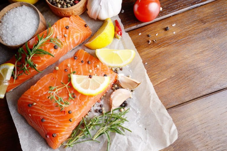 Baking a big chunk of salmon with oregano, pepper and citrus, At What Temperature Should You Bake Salmon?