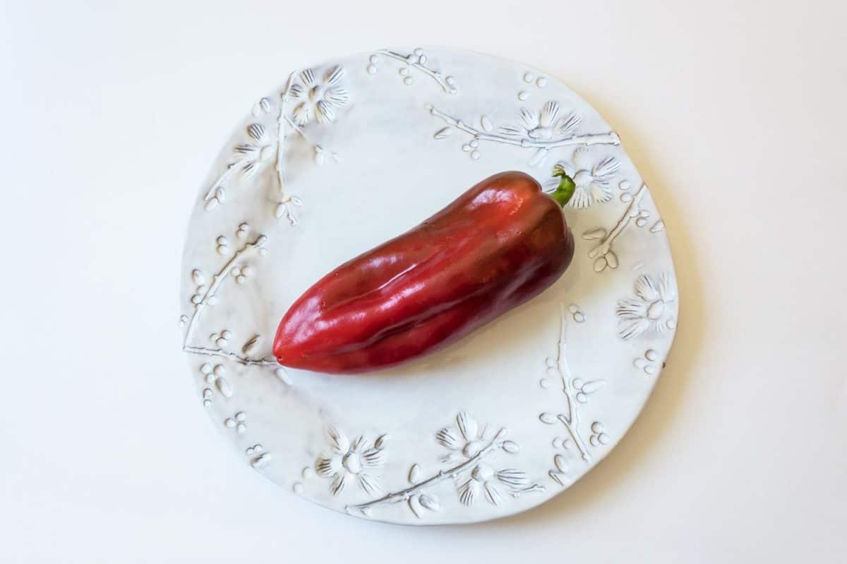 Big red ripe capsicum annuum cubanelle pepper
