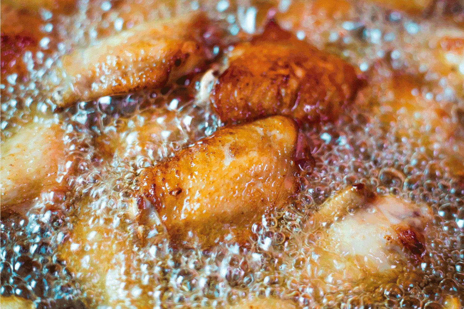 Close up fried chicken wings in boiling oil