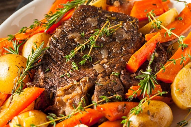 Delicious dish of pot roast with vegetables and potatoes garnished with oregano photographed up close, What Is The Best Cut Of Roast For Instant Pot?