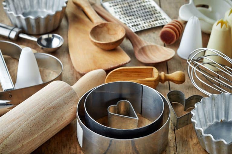 Different kinds of wooden and stainless baking utensils on the table, Can Wood Dishes And Utensils Go In The Microwave?
