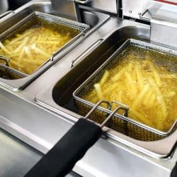 French fries or potato chips deep frying in oil in a commercial metal fryer in a restaurant as an accompaniment to meals, How Long To Fry French Fries?