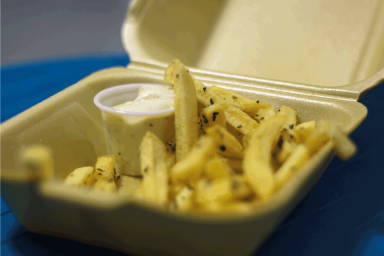 French fries with garlic sauce on Disposable container. French Fries Too Soft And Soggy - What To Do
