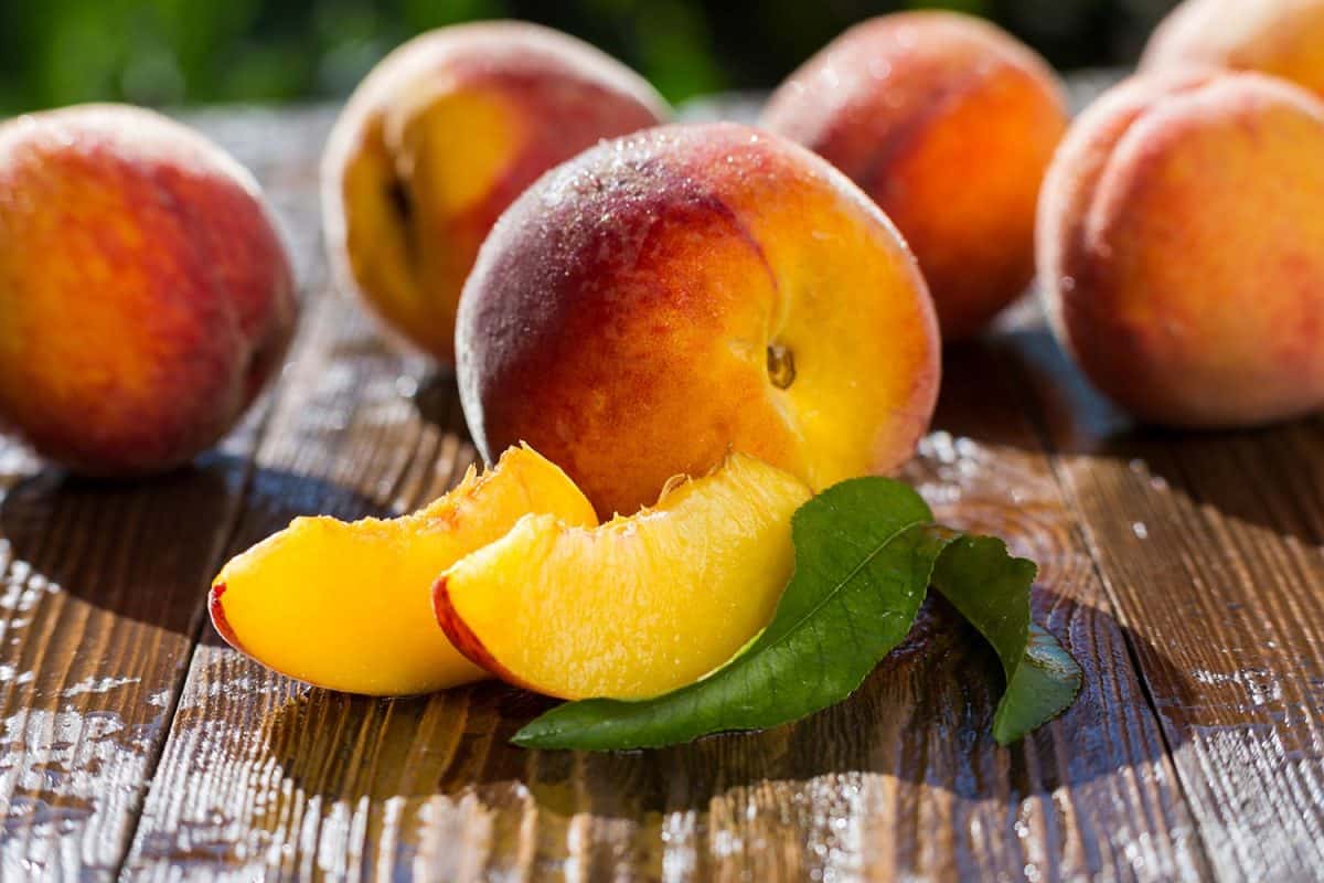 Fresh peaches on wooden table