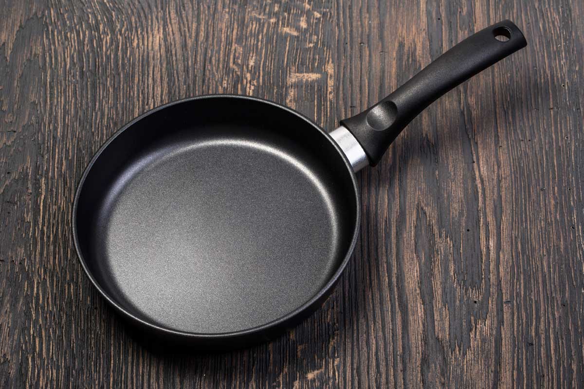 Frying pan on wooden table