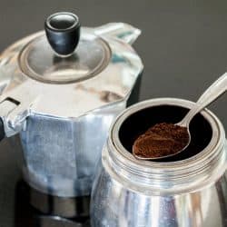 Grinded coffee on spoon in Italia coffee maker, How To Keep Coffee Grounds Out Of A Percolator