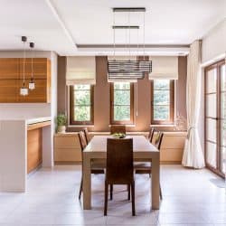 Kitchen and dining room in modern house with curtains and window blinds, Curtains VS Blinds For Kitchen Windows - Which To Choose?