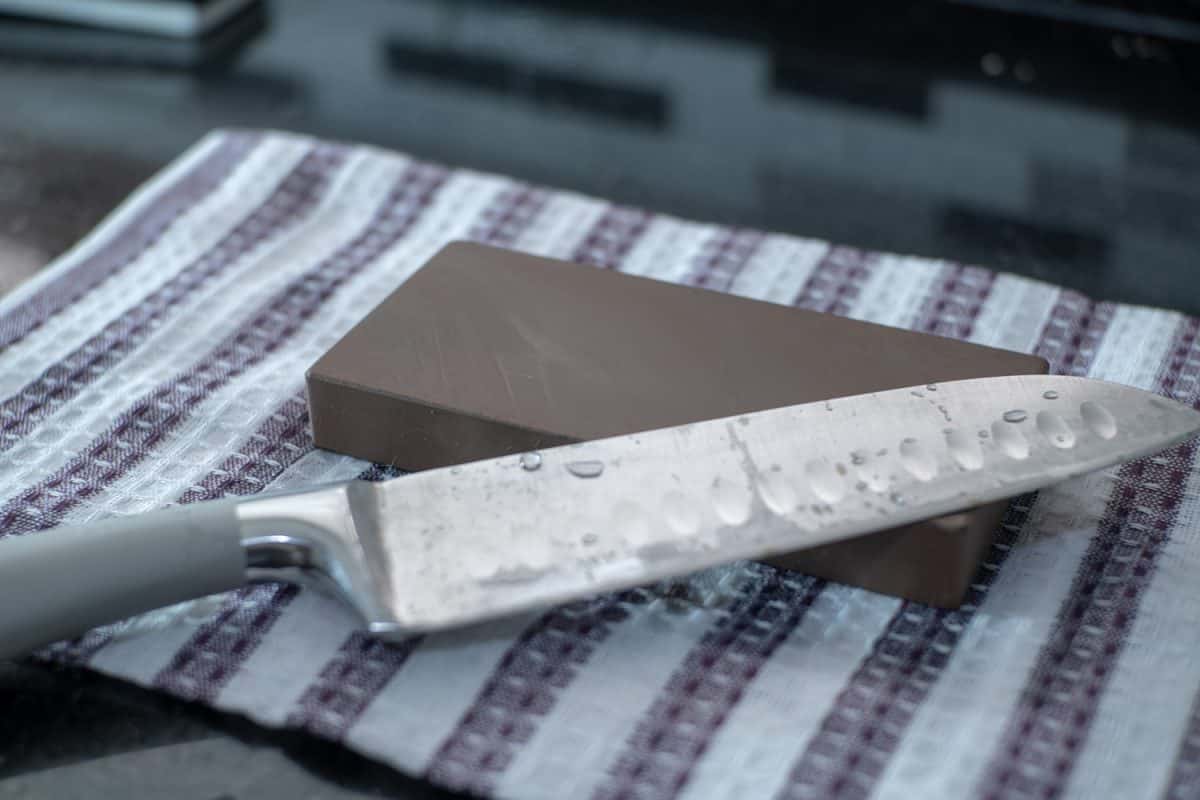 Knife Sharpening on Wet Whetstone , Santoku chef knife close up