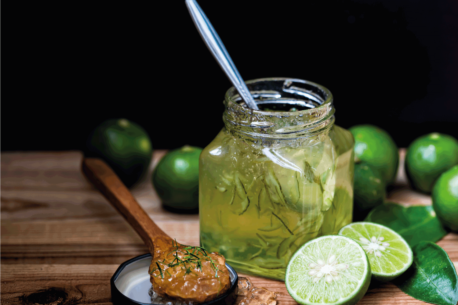Lime jam in a glass bottle on the wooden floor