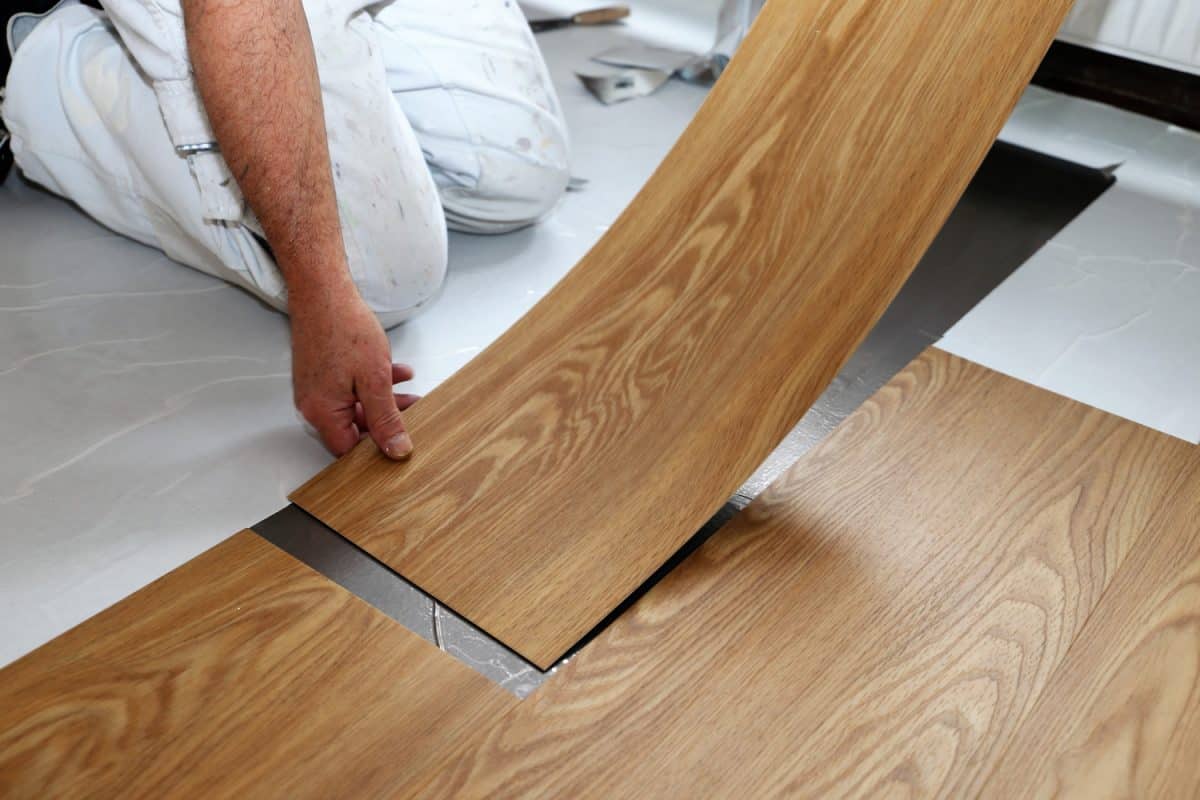 Man laying professional PVC-floor, close up