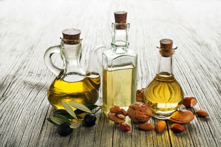Olive, walnut and almond oil on wooden background, Can You Freeze Frying Oil?