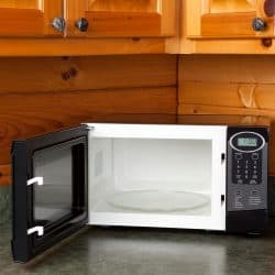 Open microwave oven on a kitchen counter in a log home, Should Microwaves Get Hot On The Outside?
