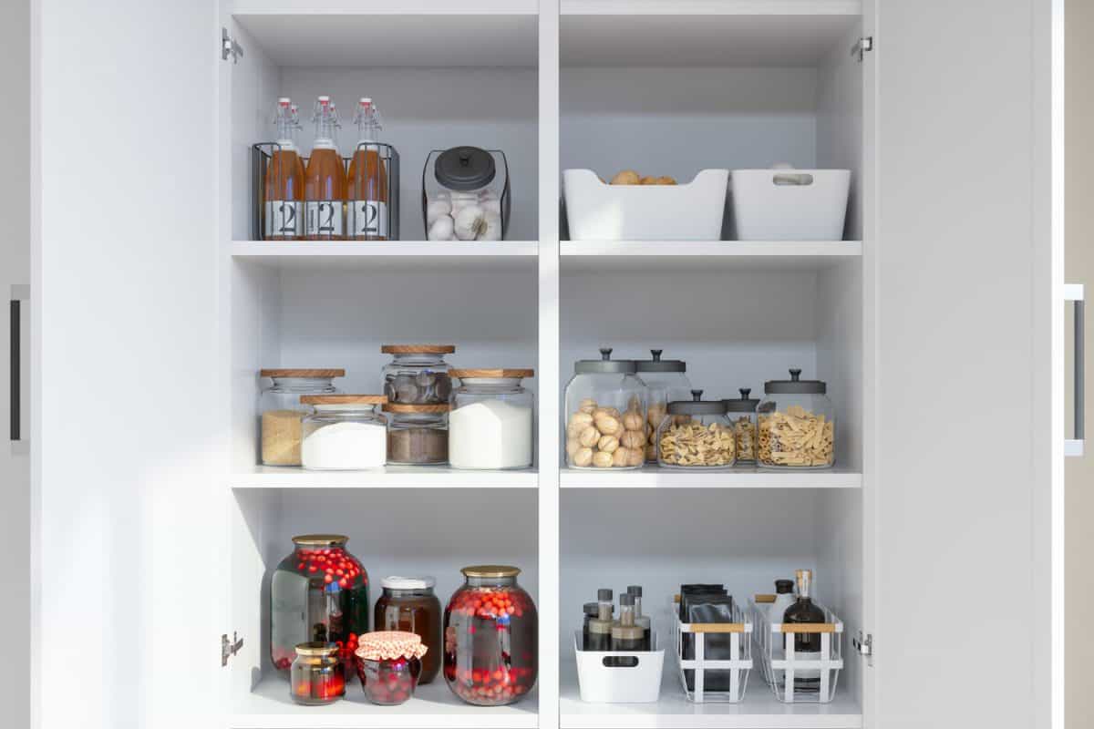Organised Pantry Items With Variety of Nonperishable Food Staples And Preserved Foods in Jars On Kitchen Shelf