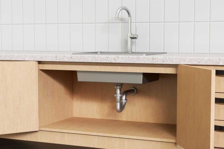 Plumbing system under a modern kitchen sink, How High Should Kitchen Sink Drain Be From Floor?