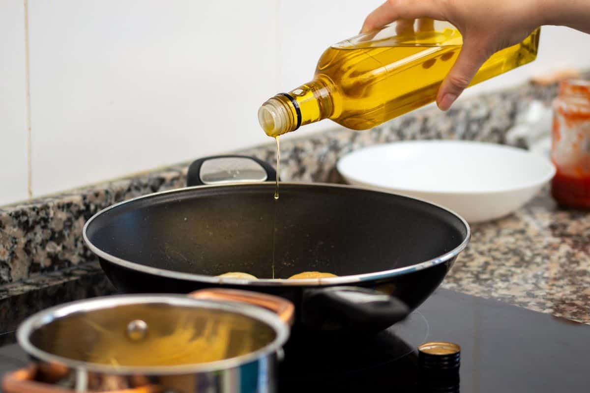 Pouring cooking oil into the frying pan