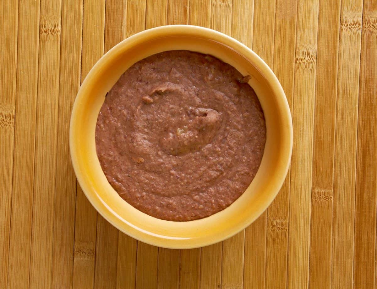 Refried beans dish of cooked and mashed beans