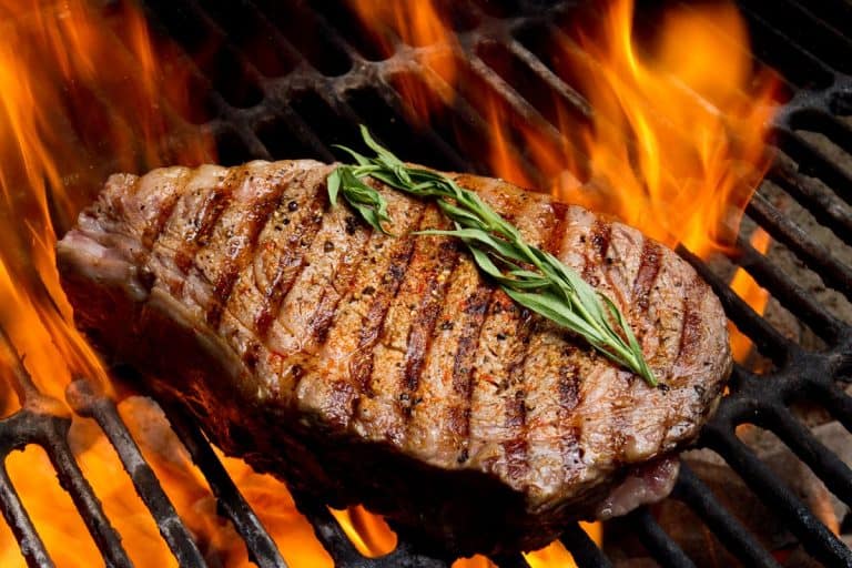 Ribeye steak on grill with fire, How Hot Should A Grill Be For Steak?