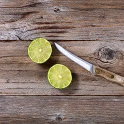 Sliced lime and paring knife on rustic wood in flat lay format, How Long Should A Paring Knife Be?