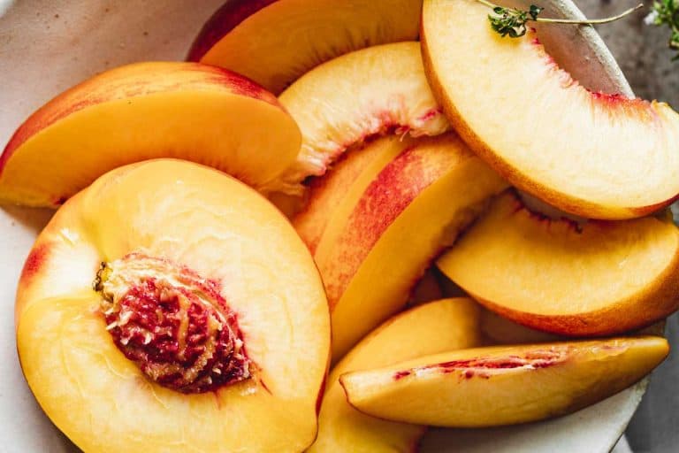 Slices of ripe peaches in a bowl, How To Store Peaches And Nectarines To Keep Them From Spoiling