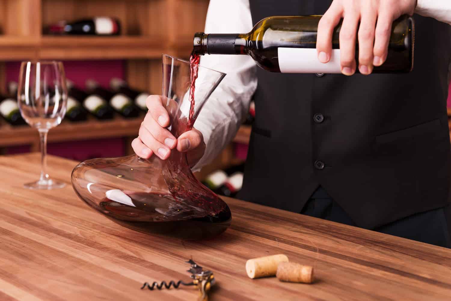 Sommelier pouring wine to decanter