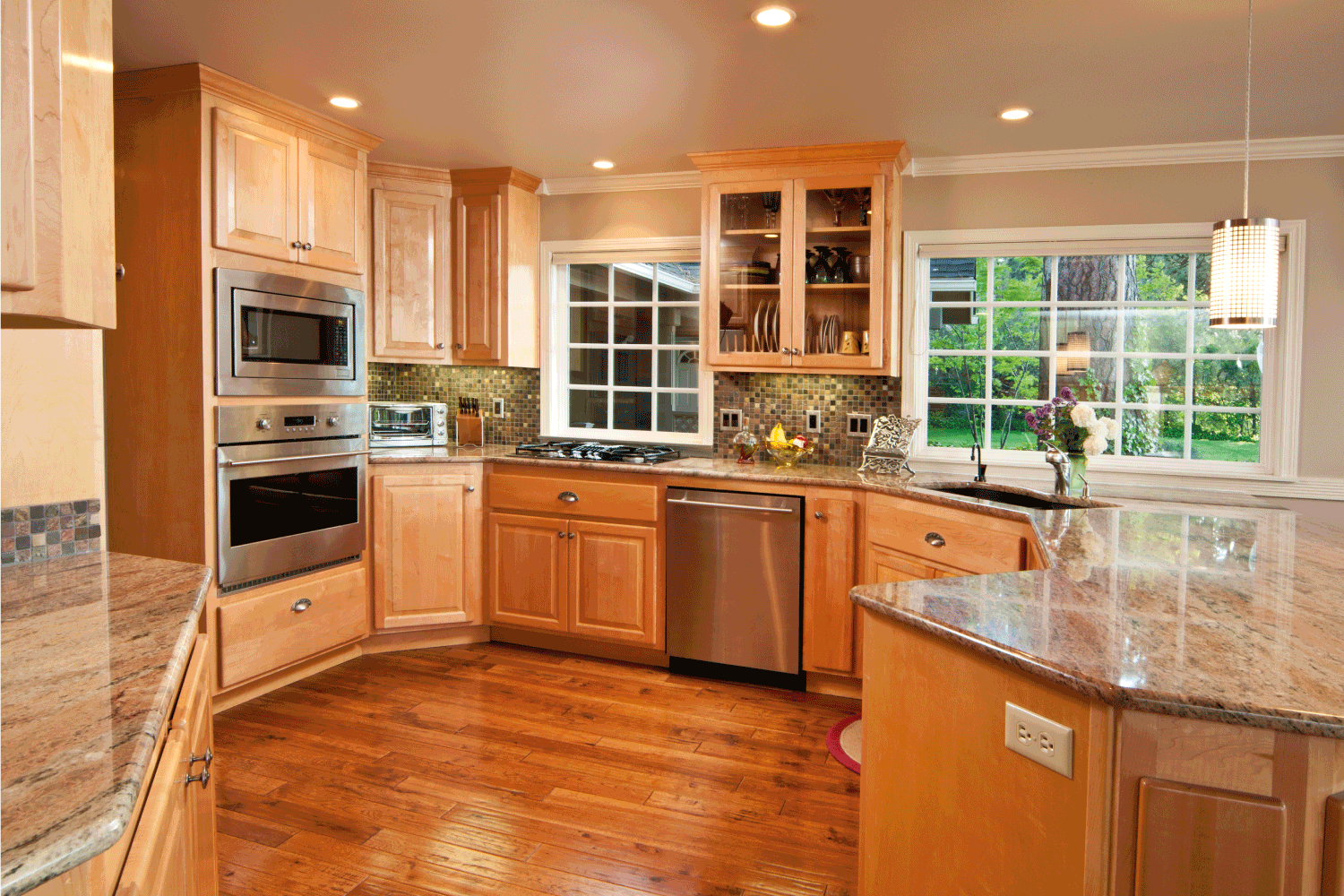 This modern kitchen gives a wide view showing the wood floor and cabinets. classic wood look