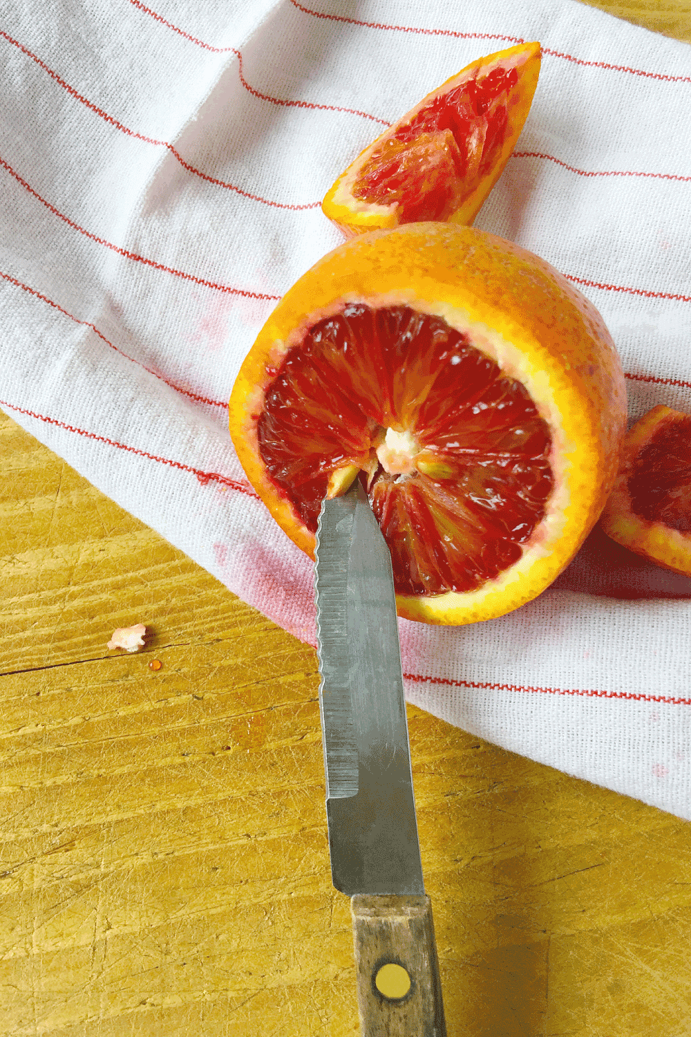 Using a knife tip to take out a seed from citrus fruit