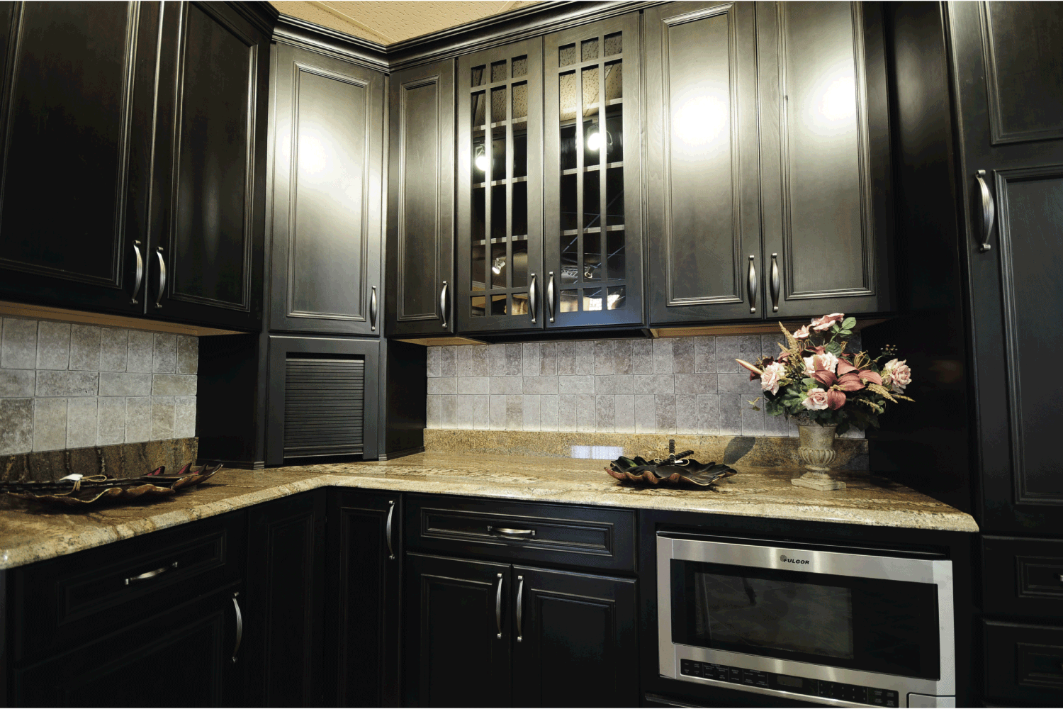dark colored kitchen cabinet with corner section continuing on to the counter top