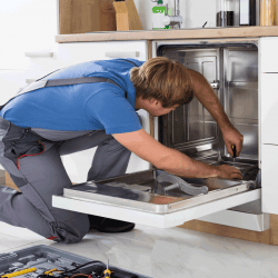 repairman taking a peek inside a dishwasher for repair. How To Replace A Bosch Dishwasher Front Panel