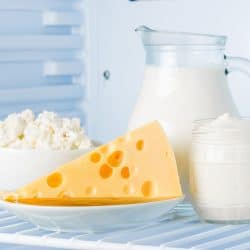 tasty healthy dairy products in the refrigerator: sour cream in the bank, cottage cheese in bowl, cheese and milk in a jar, How Long Does Cheese Last In The Fridge?