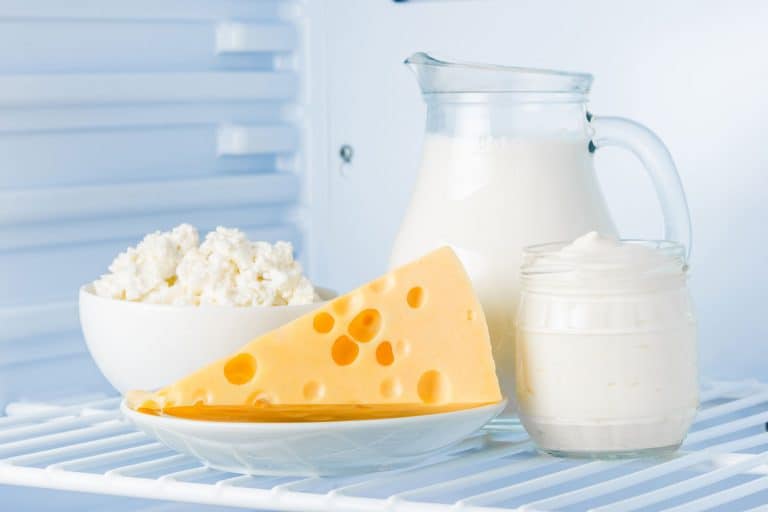 tasty healthy dairy products in the refrigerator: sour cream in the bank, cottage cheese in bowl, cheese and milk in a jar, How Long Does Cheese Last In The Fridge?