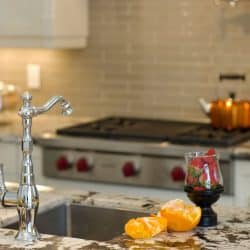 A stainless steel faucet on the kitchen breakfast bar, Should Kitchen Cabinet Hardware Match Faucet?
