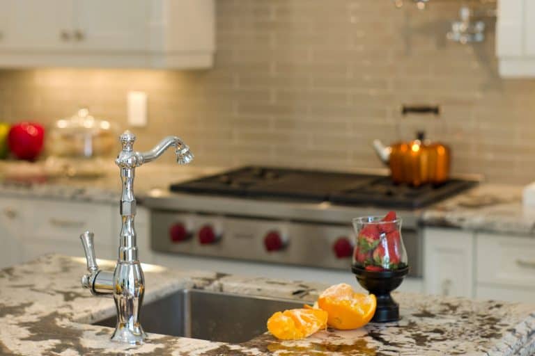 A stainless steel faucet on the kitchen breakfast bar, Should Kitchen Cabinet Hardware Match Faucet?