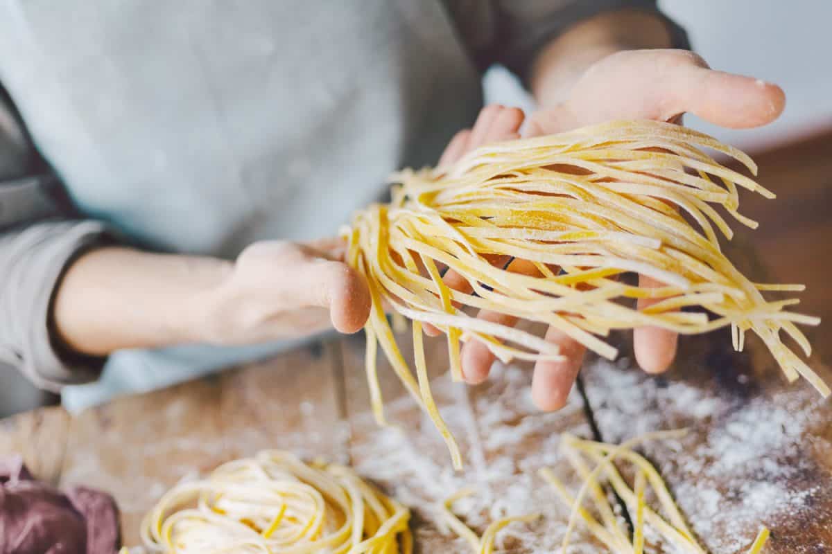 A woman holding her homemade pasta