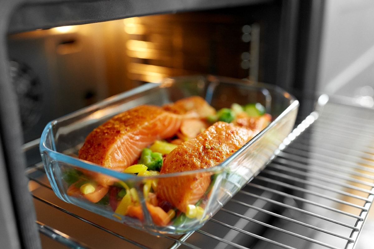 Food cooking in baking dish in oven
