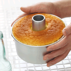 Homemade-orange-chiffon-cake-being-cooled.-What-Types-Of-Pans-For-Baking-Angel-Food-Cake