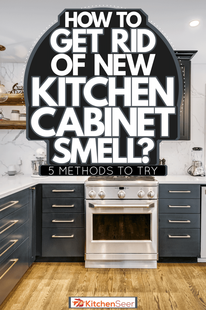 Black cabinetry inside a modern kitchen with white kitchen countertops and wooden flooring, How To Get Rid Of New Kitchen Cabinet Smell—5 Methods To Try