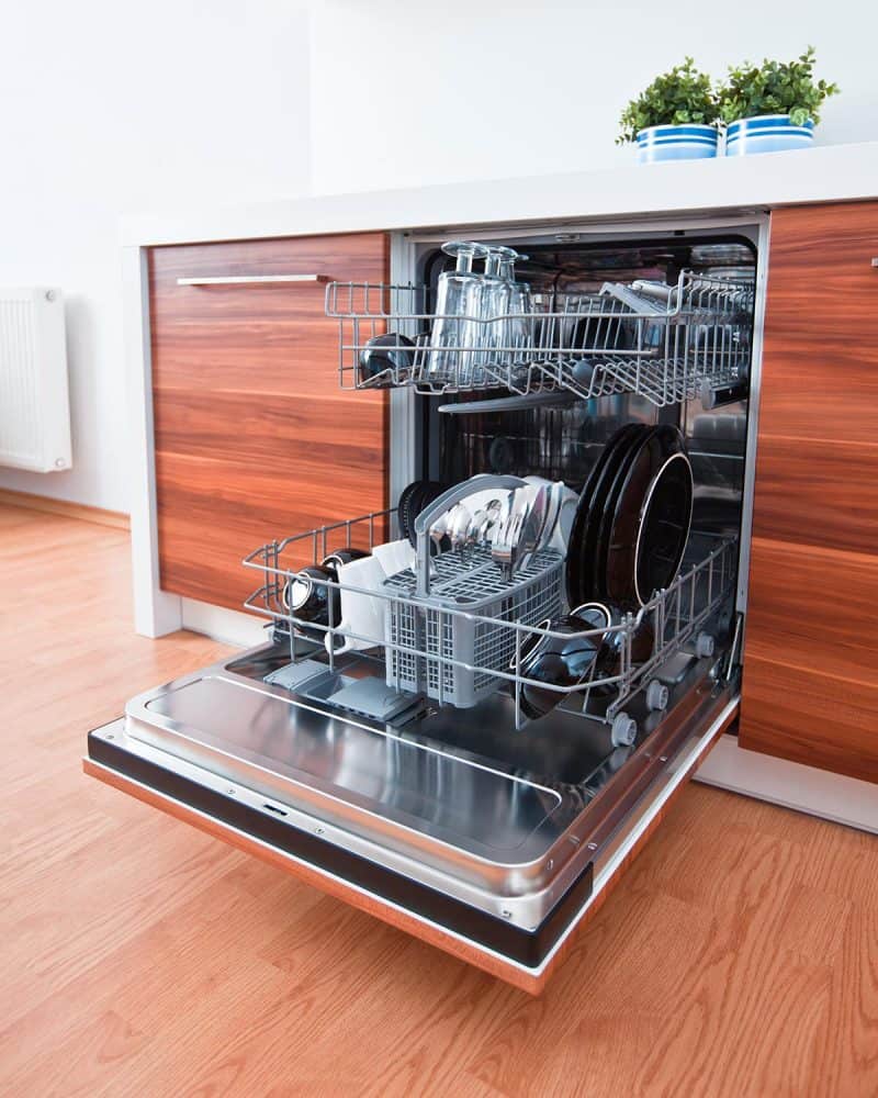 Open dishwasher with clean dishes in a modern kitchen