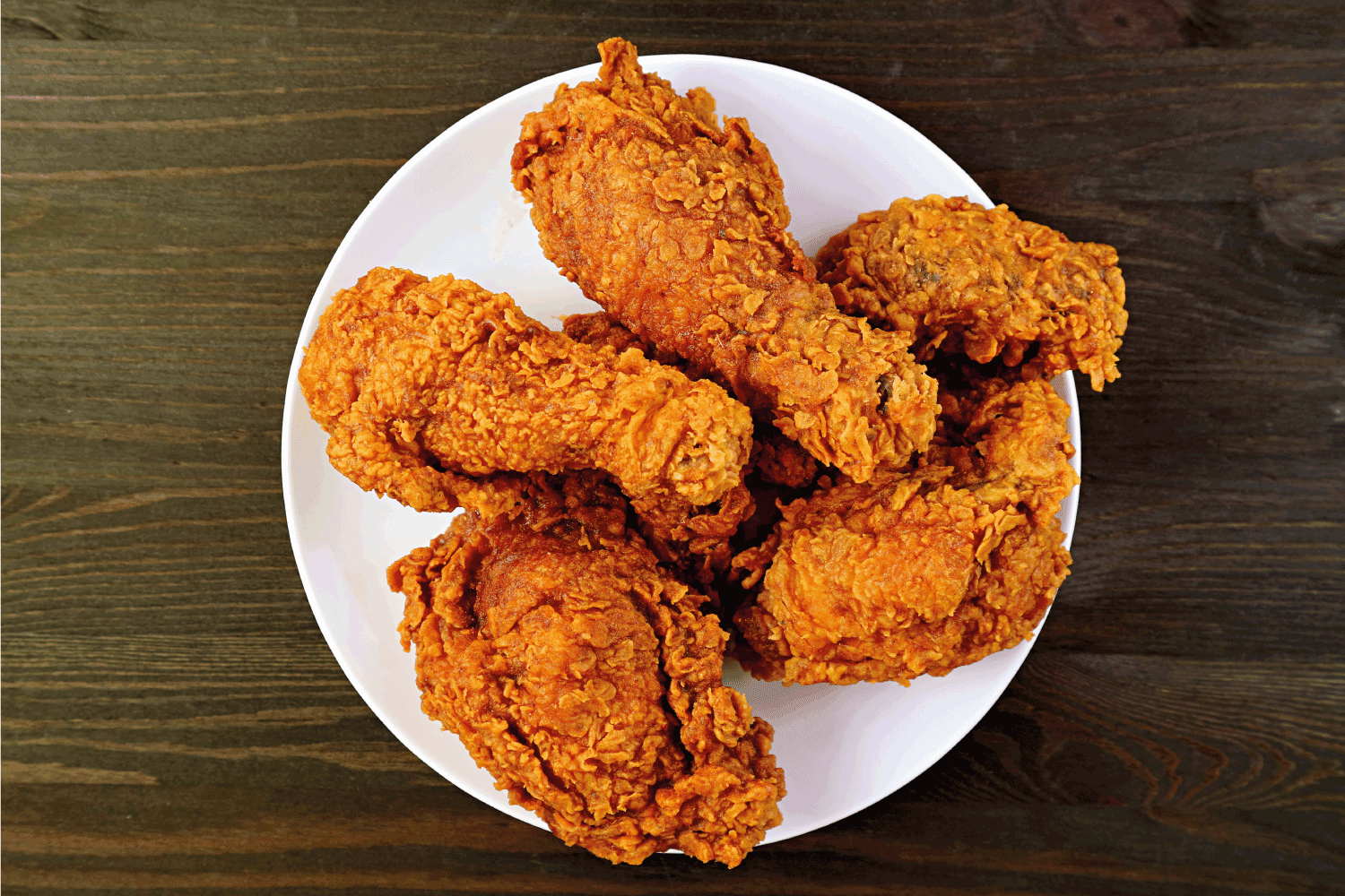 Plate of Delectable Golden Brown Crispy Fried Chickens on Wooden Background