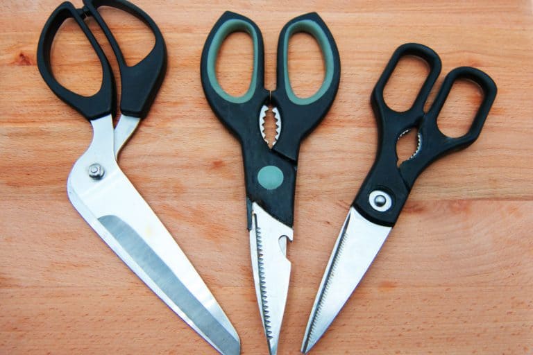 Three different kitchen scissors on the wooden table, What Is The Middle Part Of Kitchen Scissors For?