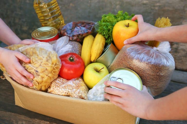 Two people stacking food in the cardboard box, How To Monitor Storage Temperatures In Your Kitchen