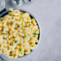 A bowl of delicious mac and cheese served in a small pot, At What Temperature Should You Bake Mac And Cheese?