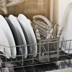 A dishwasher filled with newly washed dishes, How Much Electricity And Water Does A Countertop Dishwasher Use?