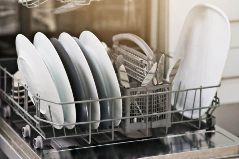 A dishwasher filled with newly washed dishes, How Much Electricity And Water Does A Countertop Dishwasher Use?