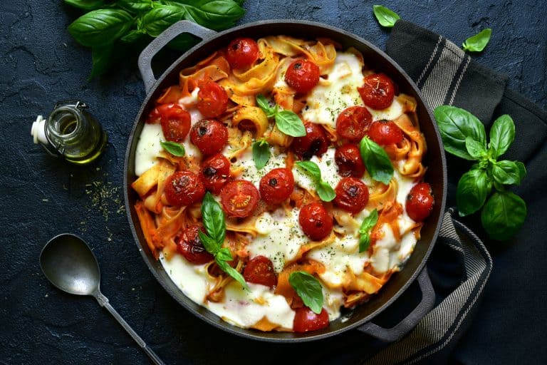 A pasta casserole with tomatoes, basil and mozzarella cheese inside a pot, What's The Best Pot For Cooking Vegetables?