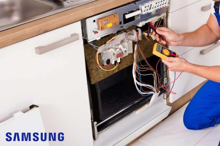 A repairman fixing dishwasher, Samsung Dishwasher Leak Sensor Alarm But No Leak - What To Do