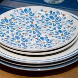 A stack of blue plates with flowers on the table, Can Corelle Dishes Go In The Air Fryer Or Oven?