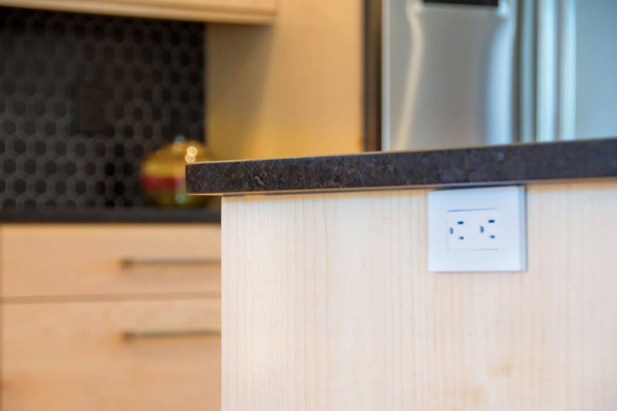 A white kitchen socket on the side of a kitchen island