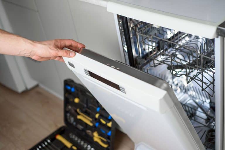 A worker repairing the dishwasher door, Can't Open Dishwasher Door—What To Do?