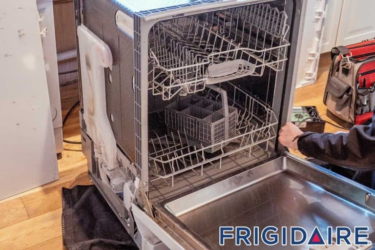 An engineer opens up a broken dishwasher to mend it, Frigidaire Dishwasher Won't Start - What To Do?